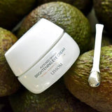 Lissom Avocado Smash Brightening Eye Cream with silver applicator surrounded by fresh avocados